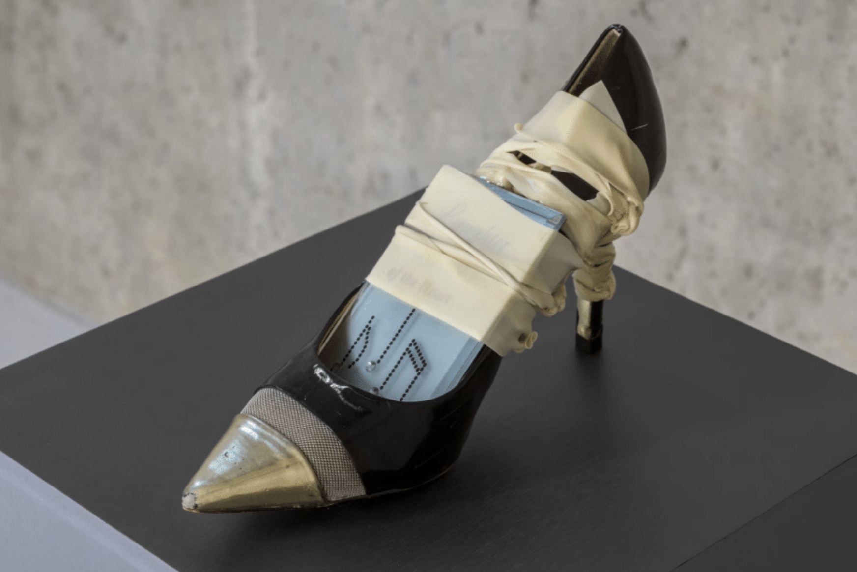 A high heeled shoe with a metal pointed toe.