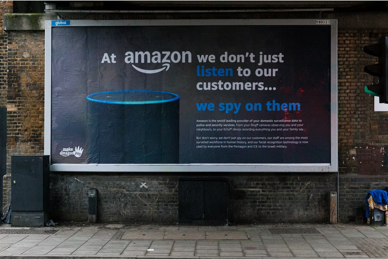 A billboard showing a spoof of an Amazon Alexa advert with the statement "At Amazon we don't just listen to our customers... we spy on them".